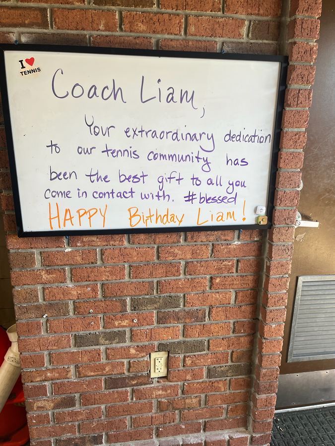 A whiteboard message from players: “Coach Liam, your extraordinary dedication to our tennis community has been the best gift…”