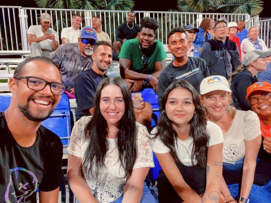 A crowd of players smiling together in the stands