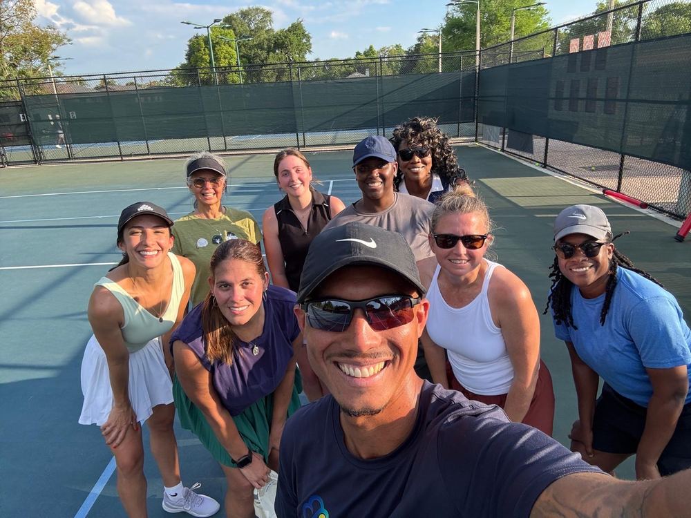 Coach Liam taking a selfie with a group of players on court