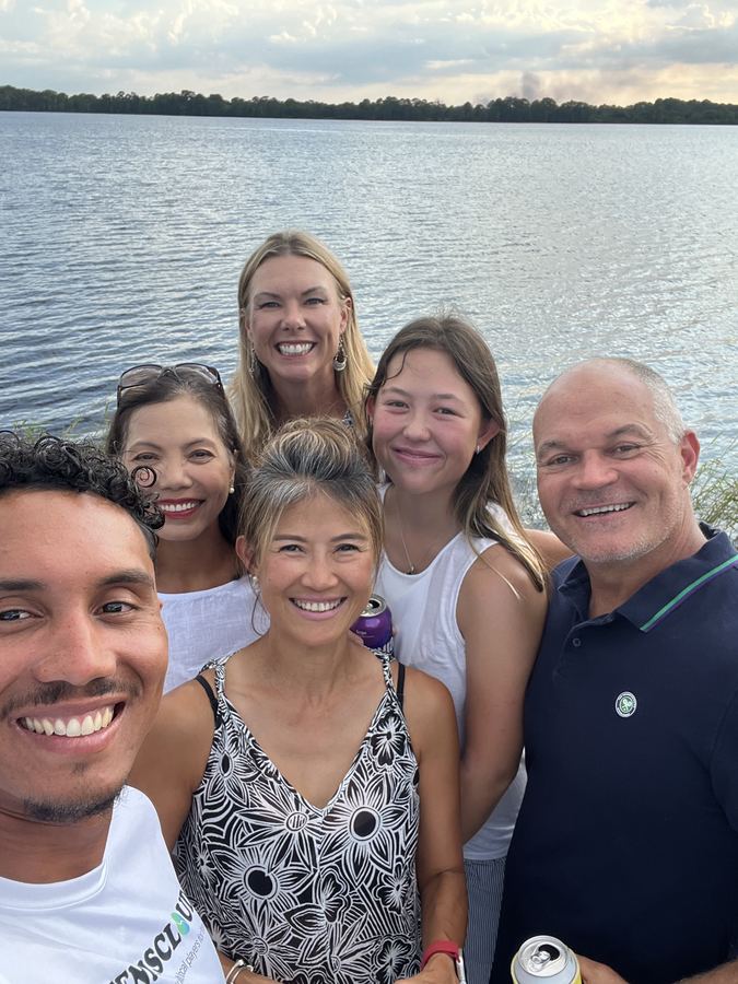Coach Liam and players taking a selfie by the lake