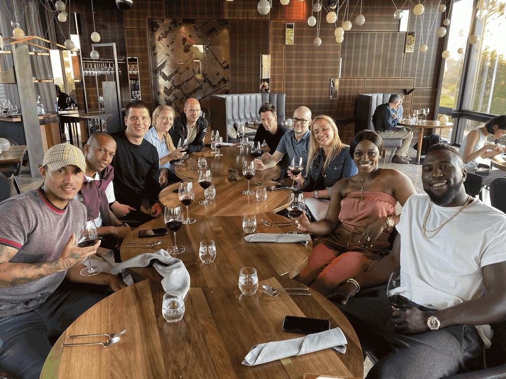 Coach Liam (front left) at dinner with Sloane Stephens and her team