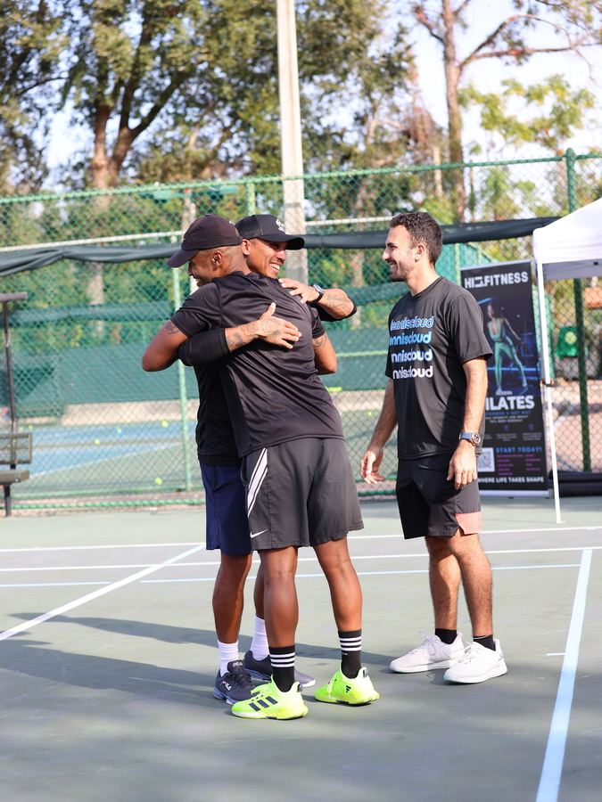 Coach Liam hugging a player on court